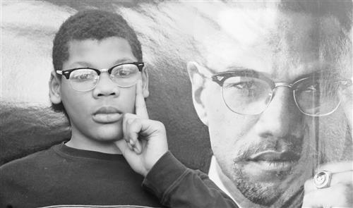 Black and white photo compilation of a student posing with the same iconic pose of Malcom X, index finger on chin.